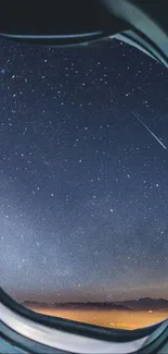 Airplane window framing a starry night sky with shooting star.