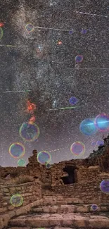 Starry night sky over ancient stone ruins, with visible meteors.