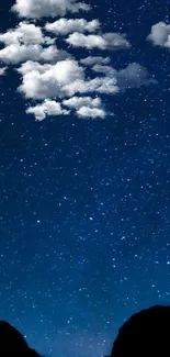 Starry night sky with clouds in deep blue hues for mobile wallpaper.