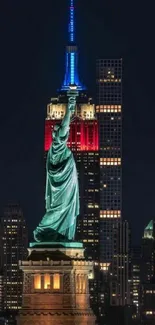 Statue of Liberty with Empire State Building at night.