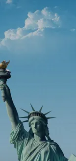 Statue of Liberty against a blue sky with clouds