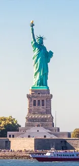 Statue of Liberty with a blue sky background, perfect for phone wallpaper.