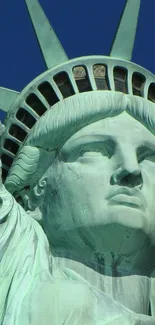 Close-up of Statue of Liberty against a blue sky.