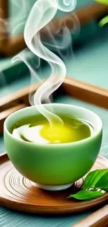 A steaming cup of green tea on a wooden tray with leaves.