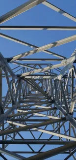 Steel lattice tower set against a bright blue sky.