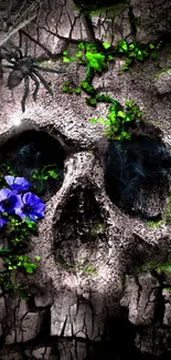 Cracked stone skull with purple flowers and green foliage.