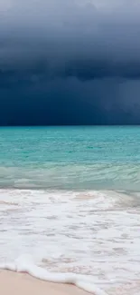 Stormy beach with turquoise ocean waves and dark clouds on the horizon.