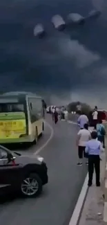 Stormy road with dark skies and UFO presence in mobile wallpaper.