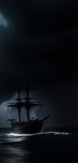 Dark ship sails under stormy night sky on the ocean.