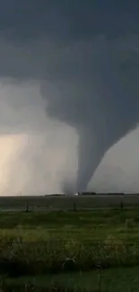 Mobile wallpaper with a dark sky and powerful tornado funnel.