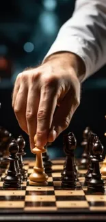 Close-up of chess player's hand moving a piece in strategic play.