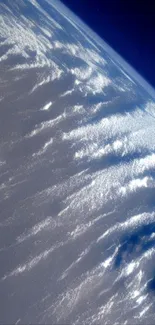 A striking view of Earth’s stratosphere showcasing blue tones and cloud patterns.