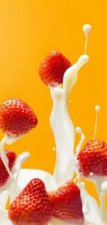 Strawberries splashing in milk on an orange background.