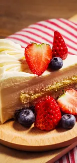Slice of strawberry cake with berries on a wooden plate.