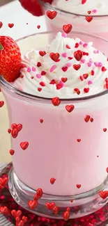 Pink strawberry drink topped with cream and a fresh strawberry.