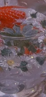 Close-up of strawberries and daisies in a sparkling glass.