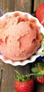 Strawberry ice cream in bowl with strawberries.