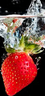 Vibrant red strawberry splashes into water on dark backdrop.