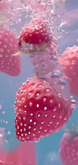 Pink strawberries submerged in water, creating a vibrant splash effect.