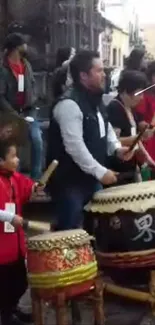 Traditional drummers performing at a lively street festival.