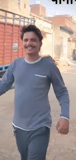 Man smiling while walking on a street.