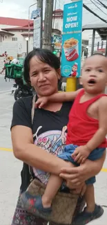 Urban street scene with mother holding child.