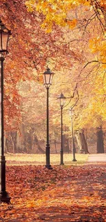 Vintage lamp posts line an autumn pathway with orange leaves in a serene park setting.