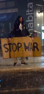 Protester holding 'Stop the War' sign in rainy street.