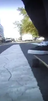 Skateboarder cruising down a city street with dynamic motion.