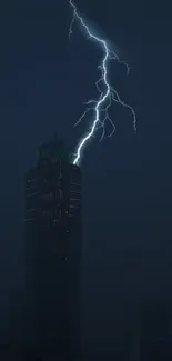 Lightning striking over city skyscraper at night.