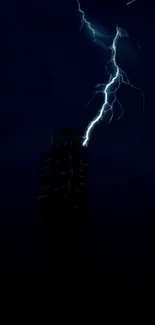 Lightning bolt strikes a skyscraper in the night sky, creating an electrifying display.