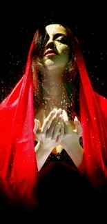 Woman in red veil with dramatic lighting on black background.