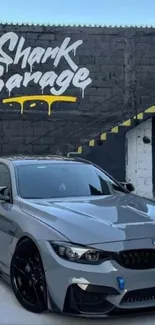 Sleek car parked in front of Shark Garage with striking graffiti.