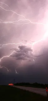 Lightning storm over a road with intense purple sky and dramatic clouds.