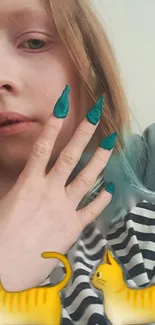 Young person with teal nails and cat emojis on striped shirt background.