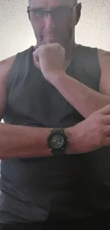 Man in gray tank top showcasing a watch.