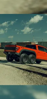 Orange 6x6 truck wallpaper with a scenic railway backdrop.