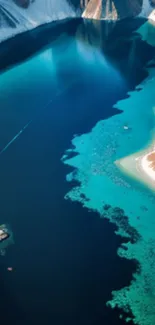 Aerial view of turquoise lake with snowy mountains