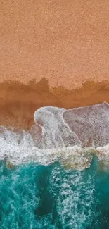 Aerial view of a turquoise ocean meeting a sandy beach.