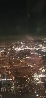 Aerial view of city lights at night, showcasing urban sprawl.