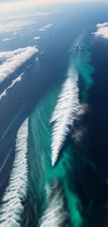 Aerial view of ocean waves with turquoise hues and vast blue skies.