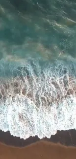 Aerial ocean view with turquoise waves and sandy beach.