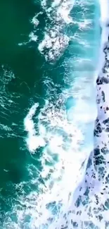 Aerial view of teal ocean waves meeting the shore with white foam.