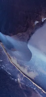 Aerial view of ocean with dark blue and white waves creating a serene pattern.