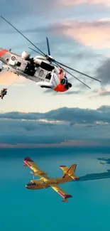 Helicopter and airplane flying over ocean at sunset.