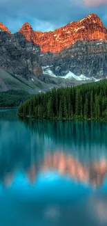 Serene alpine landscape with lake reflection under a colorful sky.