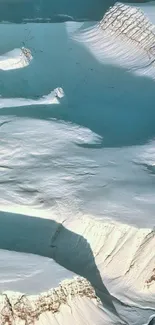 A stunning Arctic ice landscape with snow-covered mountains and a light blue sky.