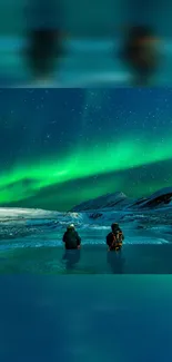 Two people under the aurora borealis with snowy mountains in the background.