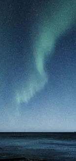 Northern lights over ocean with dark blue night sky.