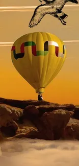 Hot air balloon at sunrise over scenic landscape with yellow sky.